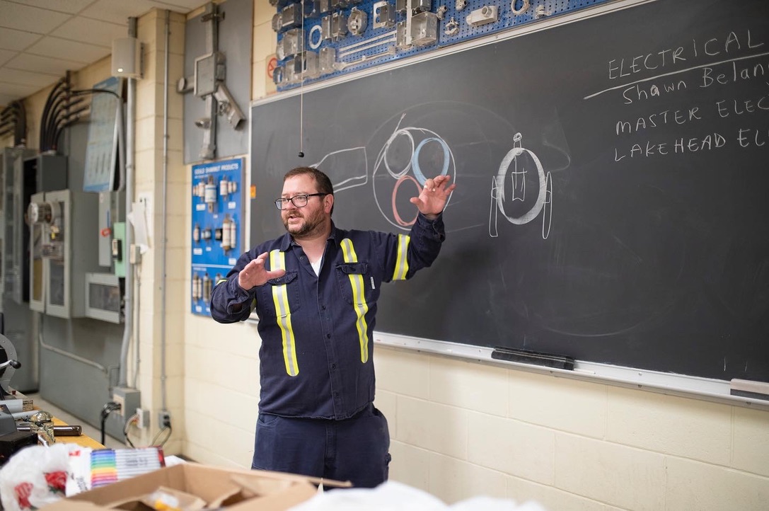 Shawn Belanger teaching electrical theory in a trade school classroom