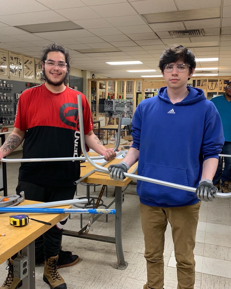 Students displaying completed electrical conduit bends during Try-a-Trade training