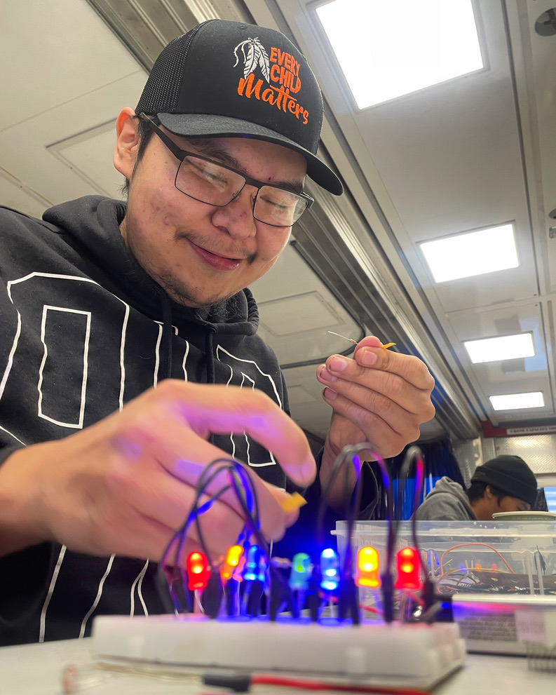Industrial electrical apprentice completing a hands-on electronics exercise at a remote mine-site training program