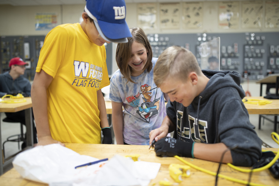 Summer-camp students collaborating on an electrical extension-cord project
